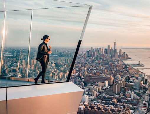 Women standing on Edge NYC observation deck overlooking Manhattan skyline.