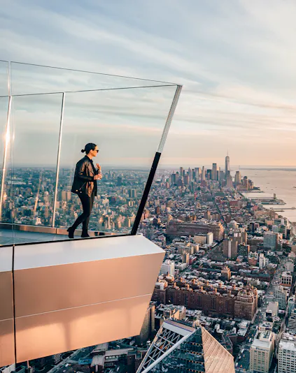 Women standing on Edge NYC observation deck overlooking Manhattan skyline.