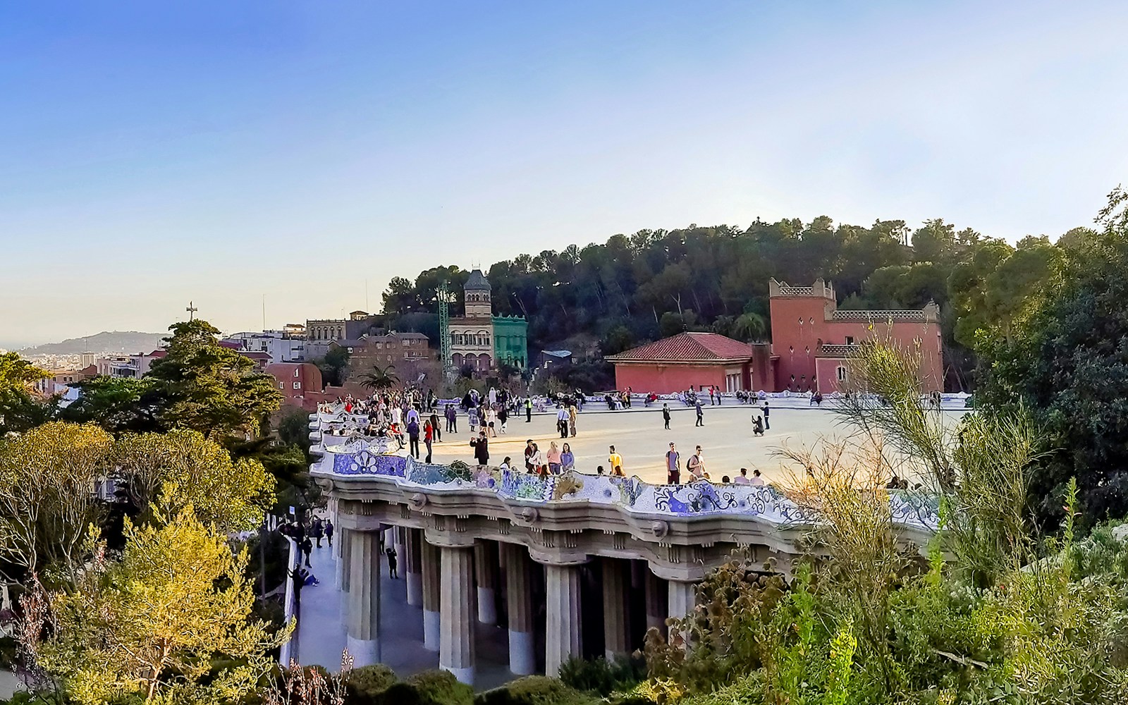 Park Guell Nature Square with colorful mosaic benches in Barcelona, Spain.