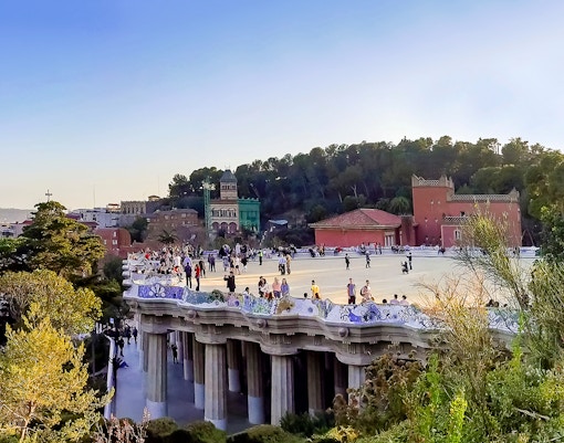 Park Guell Nature Square with colorful mosaic benches in Barcelona, Spain.