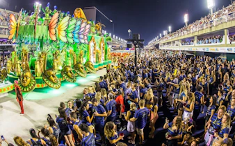 Carnival parade at Sapucaí, Rio de Janeiro, with vibrant float and large crowd in 2027.