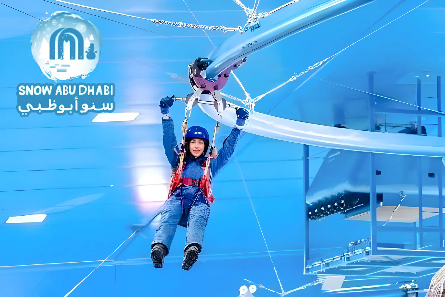 Person ziplining indoors at Snow Abu Dhabi, wearing winter gear.