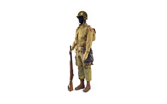 WWII soldier uniform with rifle, part of Musée de l'Armée exhibit, Paris.