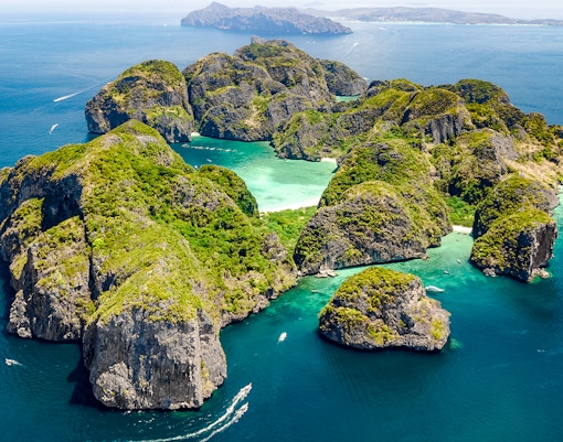 Aerial view of Phi Phi Island with boats in turquoise waters, Thailand.