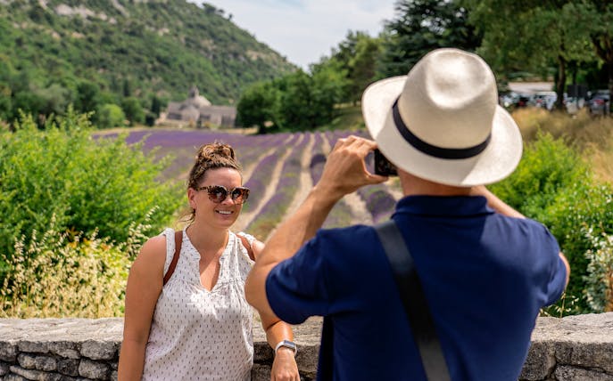 Person posing for a photo in front of lavender fields in Luberon during a morning tour.