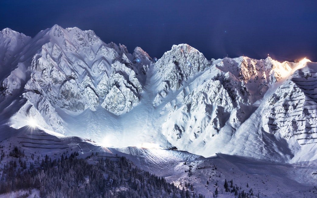 Snow-covered Nordkette mountain range at night, Innsbruck, Austria.