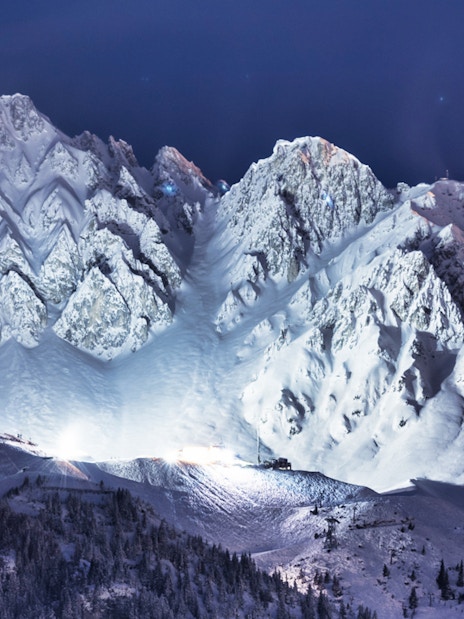 Snow-covered Nordkette mountain range at night, Innsbruck, Austria.