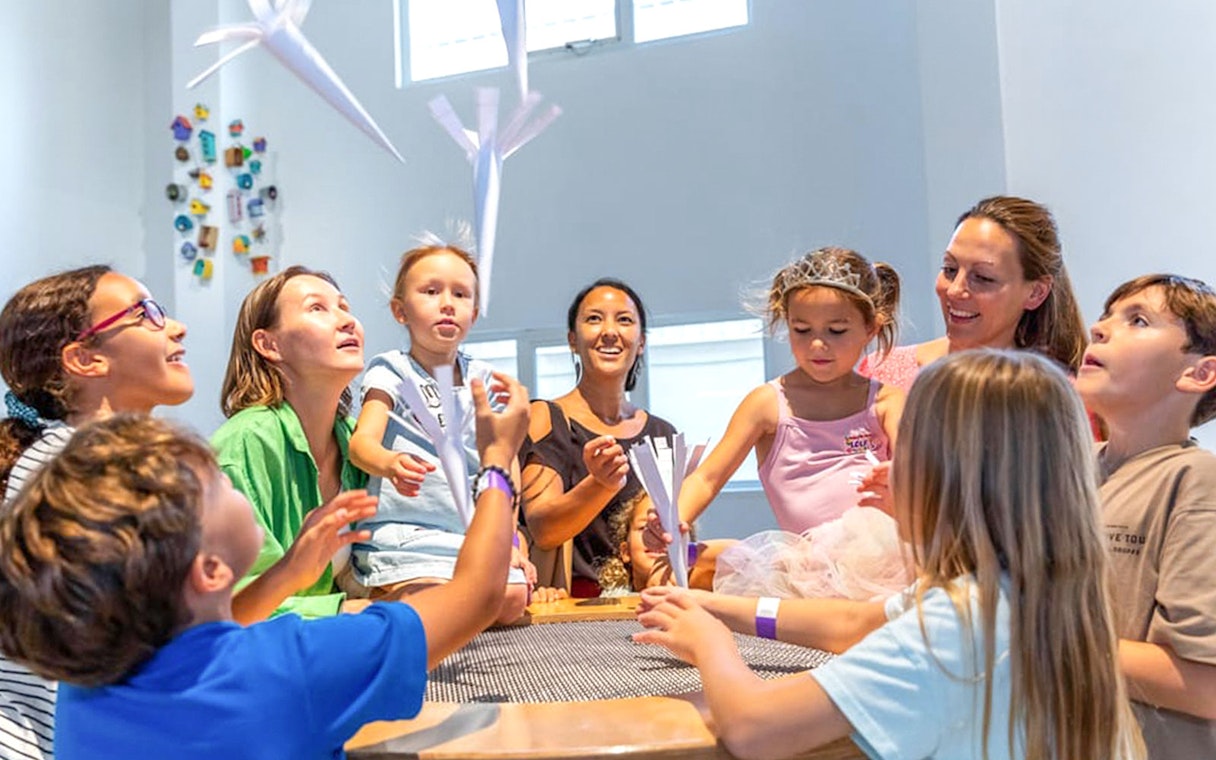 Kids and mother interacting with air exhibit at Olioli Children's Play Museum Dubai.