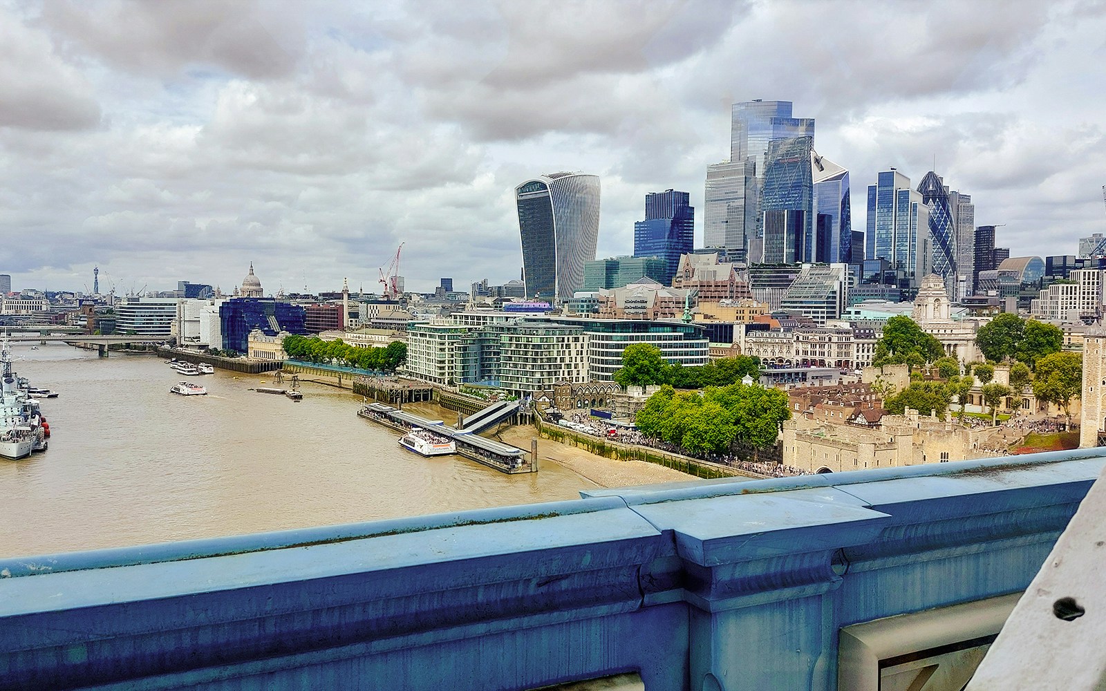 View of London skyline and Thames River from Tower Bridge.