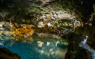 Jameos del Agua cave with turquoise pool and rock formations in Lanzarote.