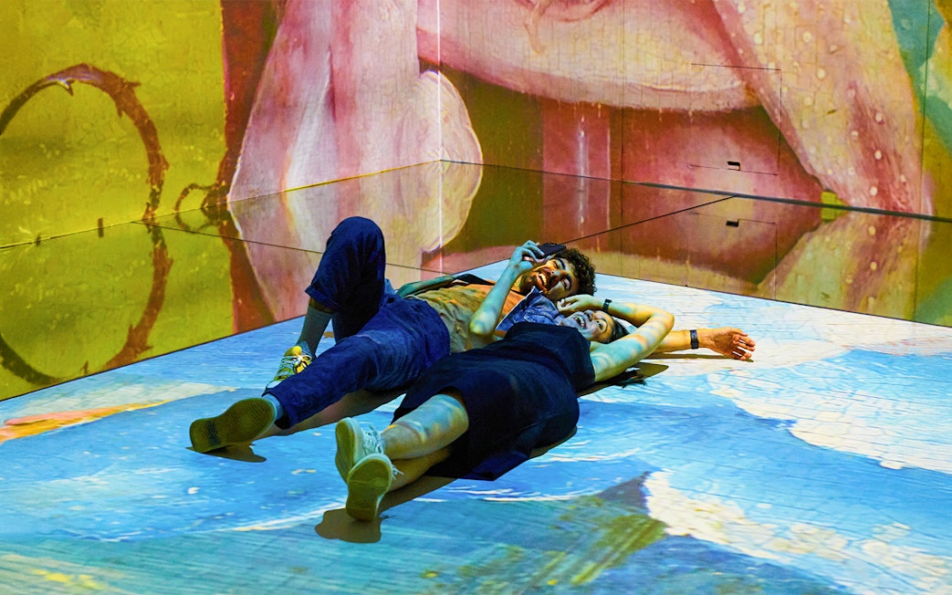 Couple enjoying immersive art experience at Frameless.