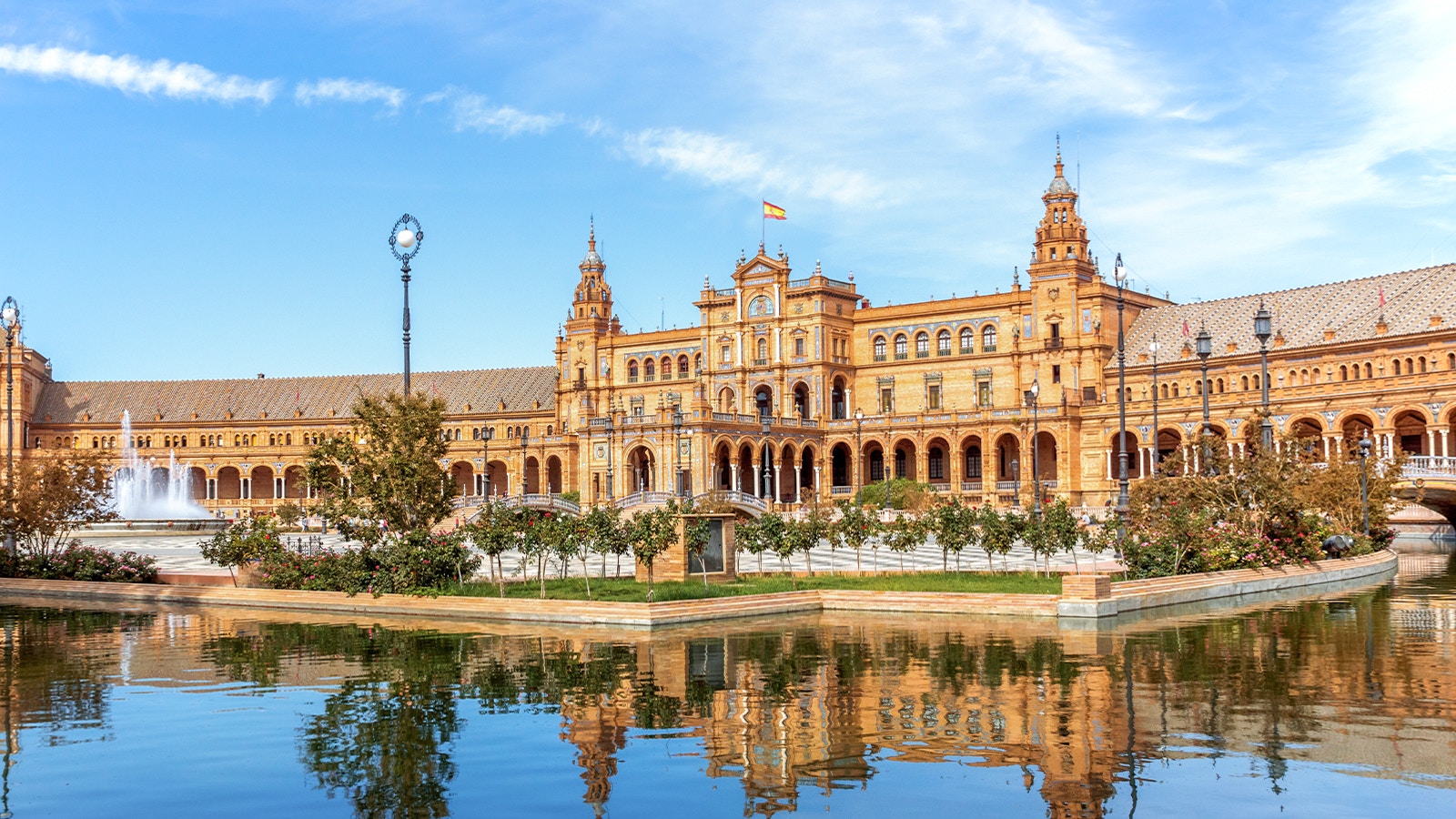 Plaza de España in Seville with its iconic architecture and reflecting pool.