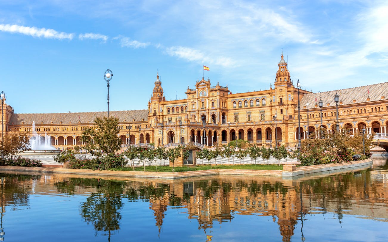 Plaza de España in Seville with its iconic architecture and reflecting pool.