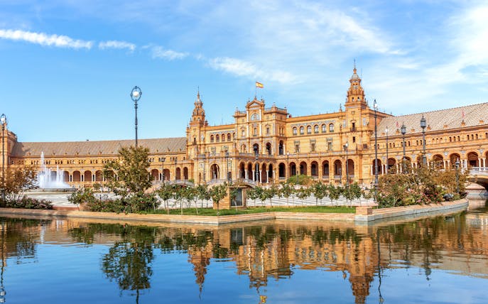 Plaza de España in Seville with its iconic architecture and reflecting pool.