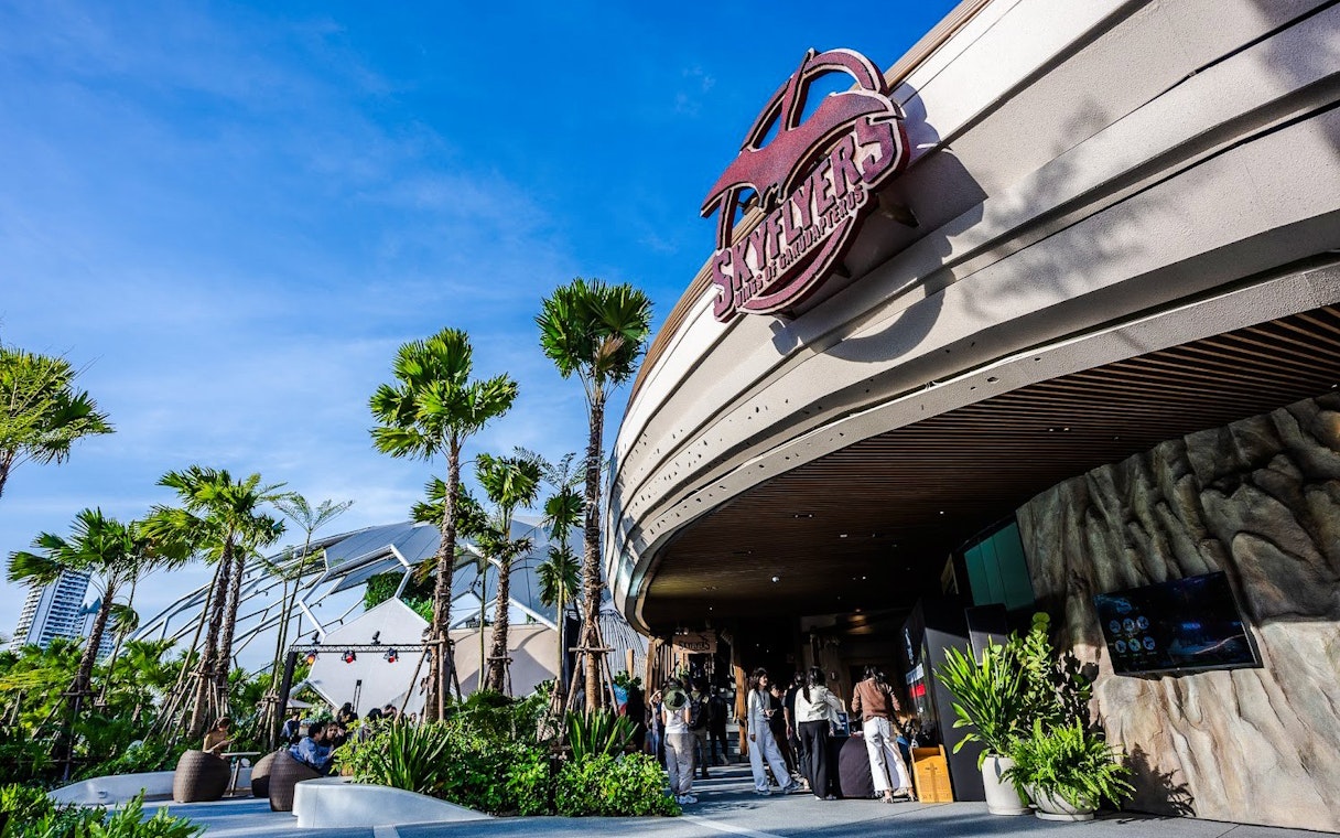 SkyFlyers entrance with palm trees and blue sky at Asiatique Bangkok.