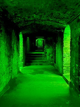 Underground stone corridor with steps on the Terror Tour in Edinburgh.