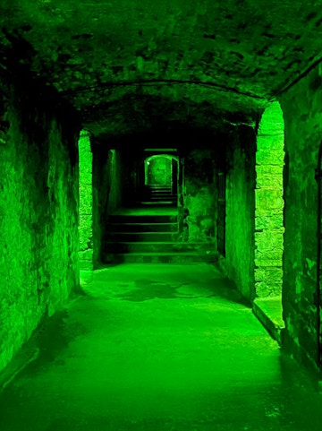 Underground stone corridor with steps on the Terror Tour in Edinburgh.