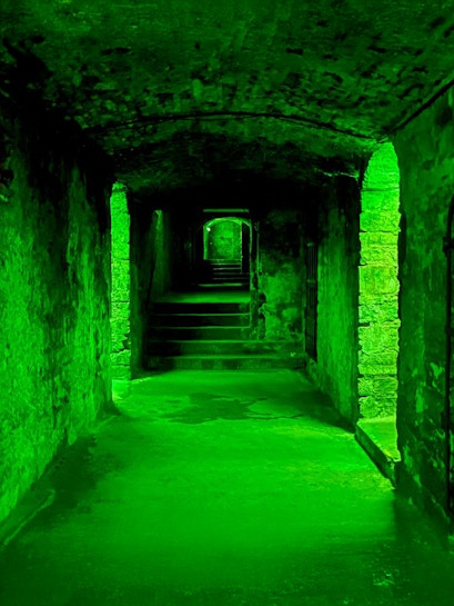 Underground stone corridor with steps on the Terror Tour in Edinburgh.