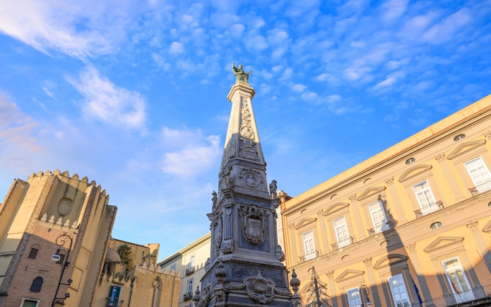 San Domenico Maggiore obelisk and surrounding architecture in Naples, Italy.