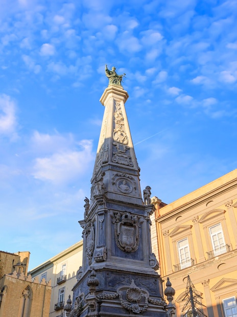 San Domenico Maggiore obelisk and surrounding architecture in Naples, Italy.