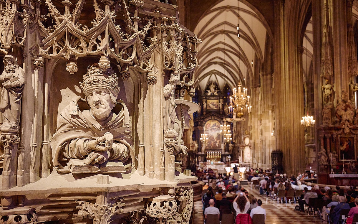 St. Stephen's Cathedral interior with ornate pulpit and audience at Giant Organ Concert.