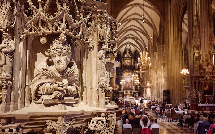 St. Stephen's Cathedral interior with ornate pulpit and audience at Giant Organ Concert.