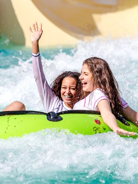 Kids enjoying a water ride at a water park in Doha.