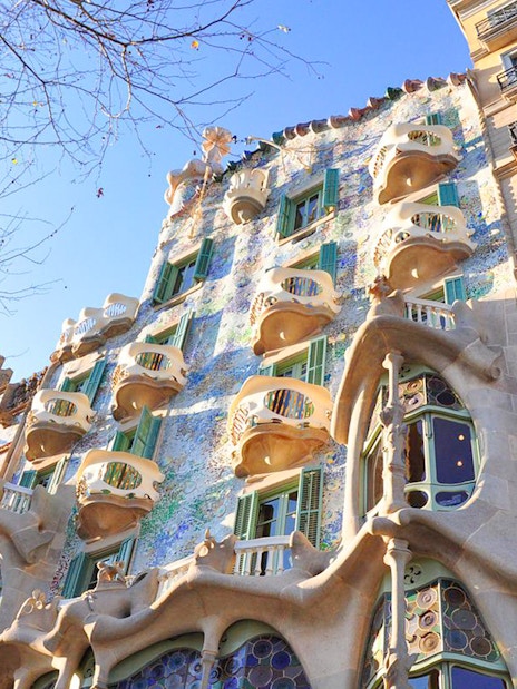 Casa Batlló's unique facade with organic shapes and colorful mosaics in Barcelona.