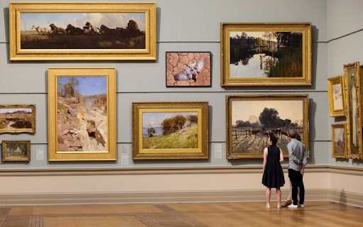 Couple viewing paintings at Art Gallery of New South Wales, Sydney.