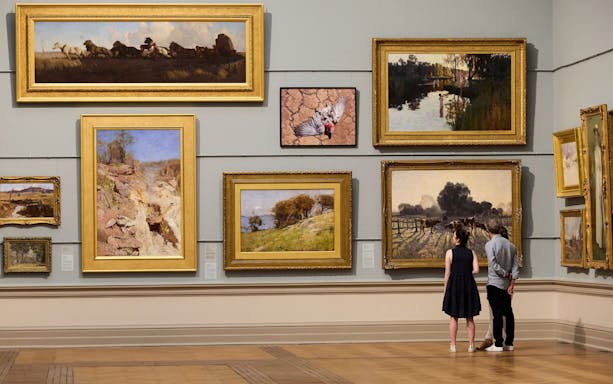 Couple viewing paintings at Art Gallery of New South Wales, Sydney.