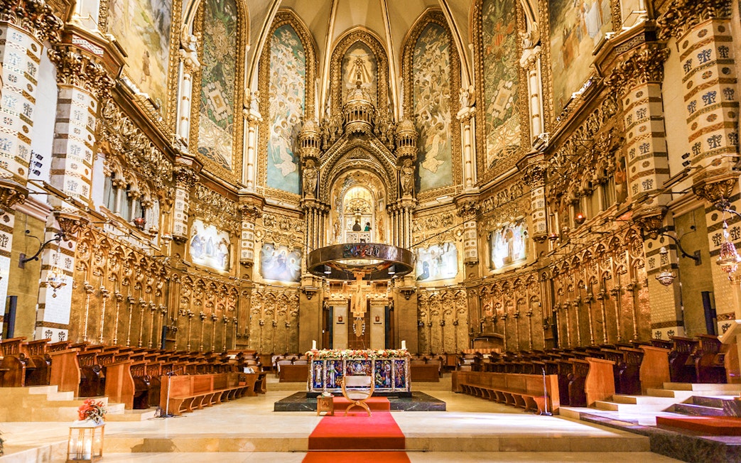 Santa Maria Church interior at Montserrat Monastery, featuring ornate altar and detailed frescoes.