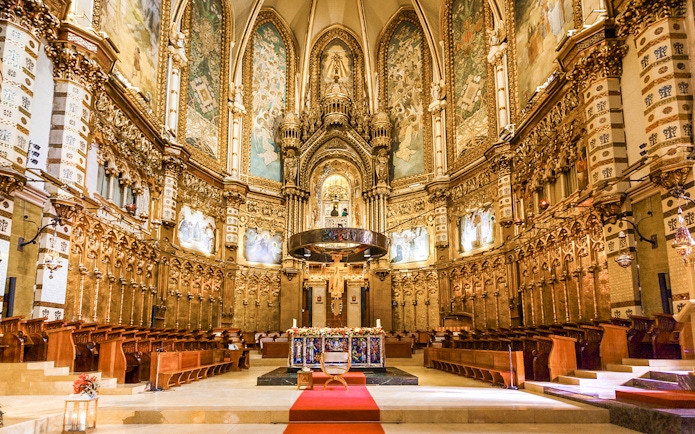 Santa Maria Church interior at Montserrat Monastery, featuring ornate altar and detailed frescoes.
