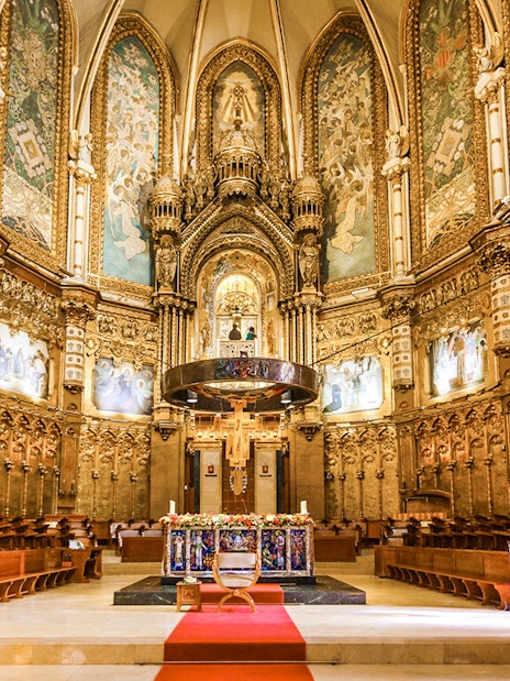 Santa Maria Church interior at Montserrat Monastery, featuring ornate altar and detailed frescoes.