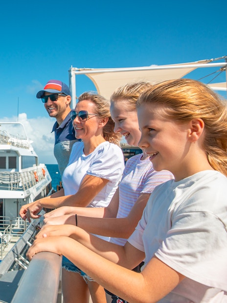 Tourists on a pontoon enjoying a cruise from Cairns to the Great Barrier Reef.