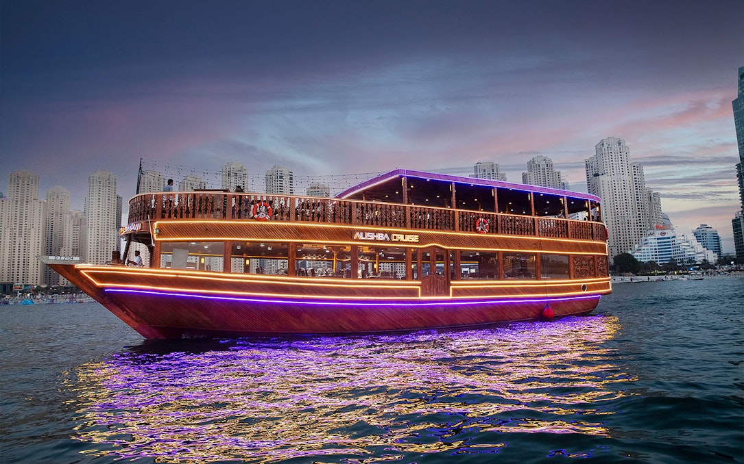Dhow cruise with lights at Marina, skyscrapers in background, Alishba Cruise.