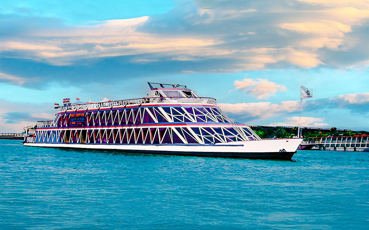 Nile cruise ship with geometric design on the river under a cloudy sky.