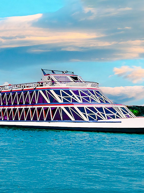 Nile cruise ship with geometric design on the river under a cloudy sky.