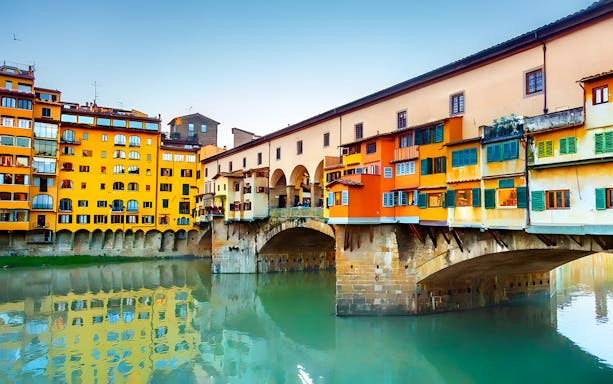 Ponte Vecchio over the Arno River in Florence, Italy, part of a full-day Tuscany tour.