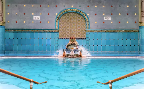Indoor pool with ornate fountain at Gellert Spa, Budapest.