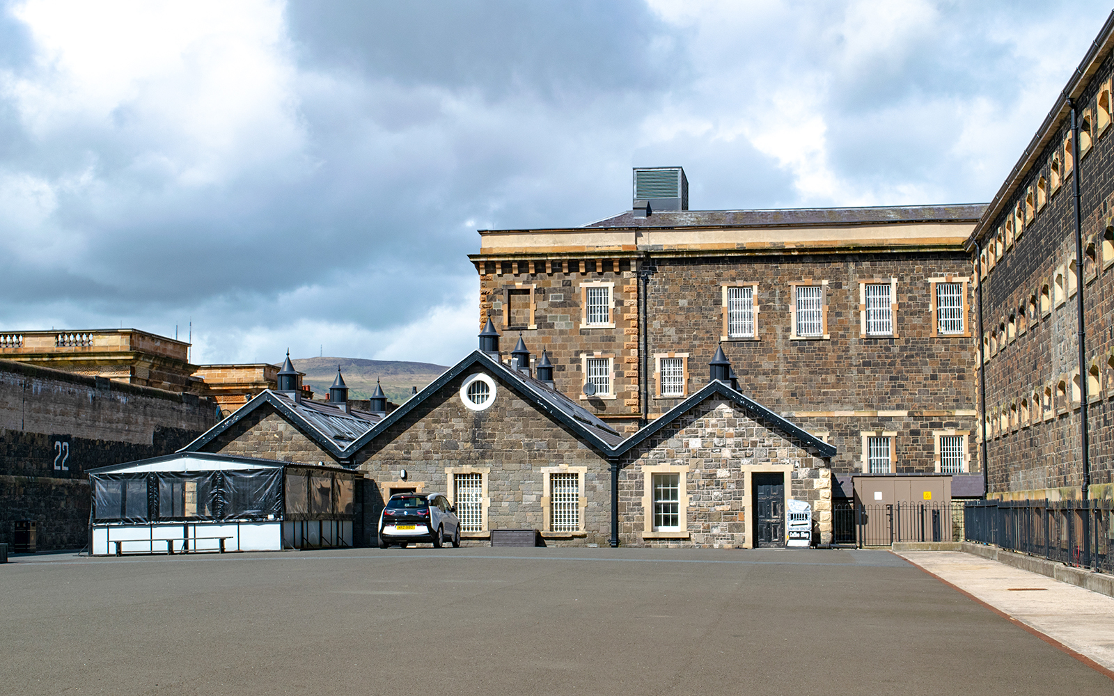 Crumlin Road Gaol exterior under a sunny sky in Belfast, Northern Ireland.
