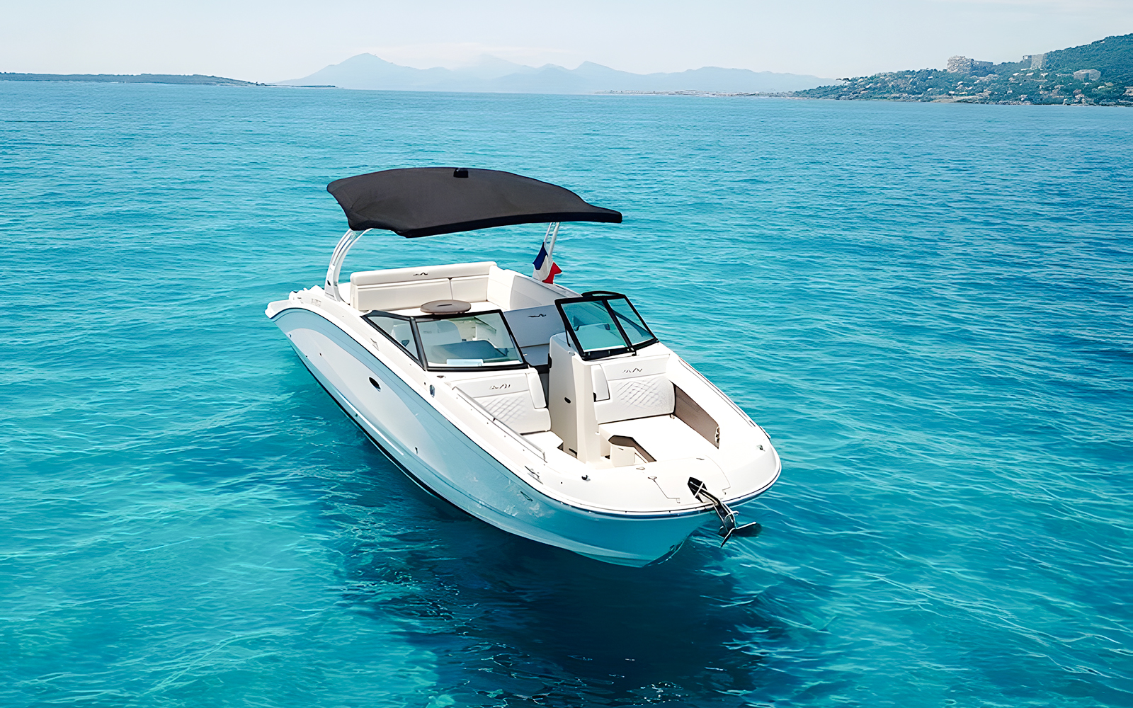 Luxury yacht Sea Ray on clear blue waters near Lerins Islands.
