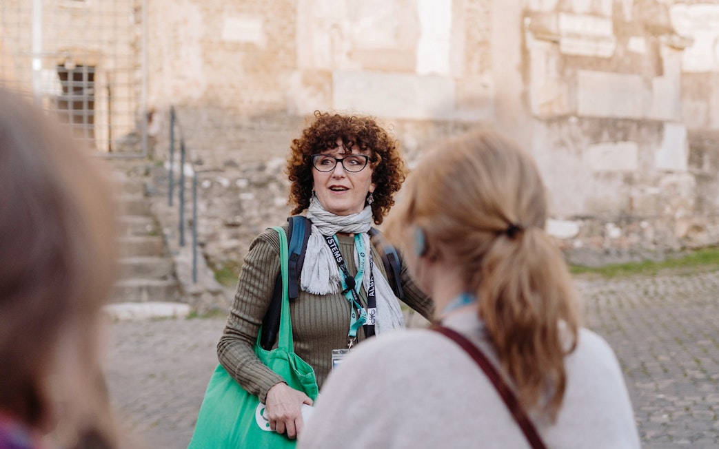 Tour guide briefing tourists on Rome Catacombs and Appian Way tour.