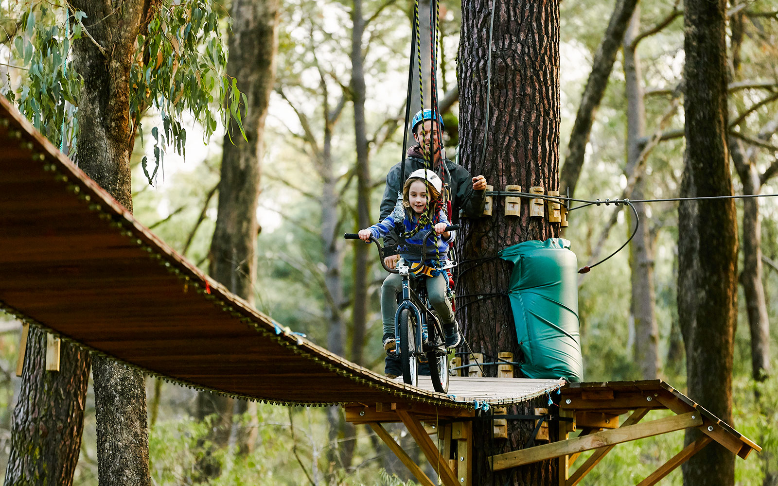Child ziplining on a bike through Ludlow Tuart Forest, Western Australia.