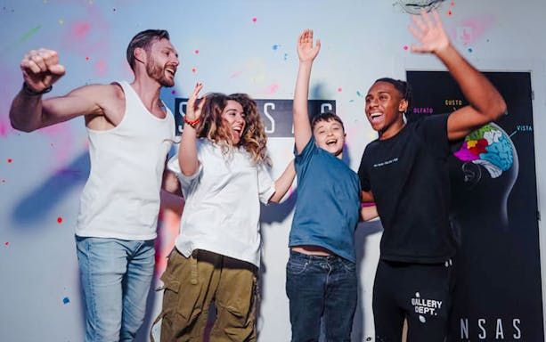 Group enjoying interactive experience at SENSAS attraction.