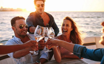 Tourists toasting on a private sunset cruise in Ibiza.