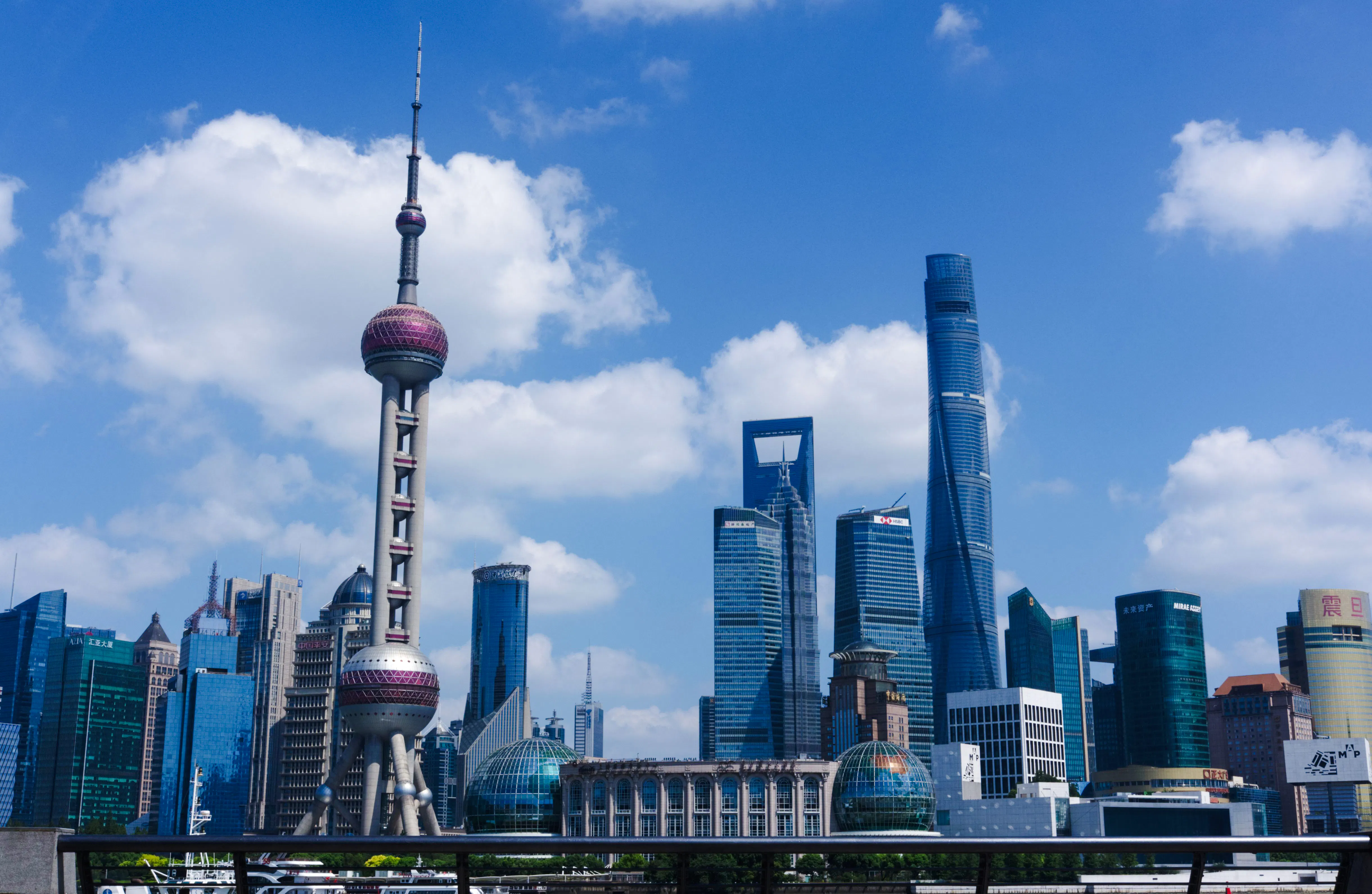 Shanghai skyline featuring the Oriental Pearl Tower on a clear day.