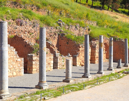 Ancient stone columns at the Roman Agora in Delphi, Greece.