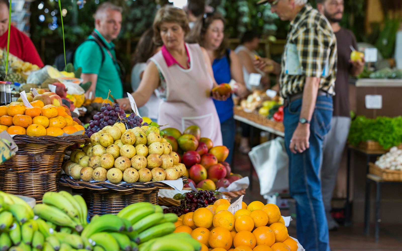 Local shoppers at Porto farm food market with fresh fruits and vegetables.
