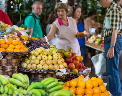 Local shoppers at Porto farm food market with fresh fruits and vegetables.