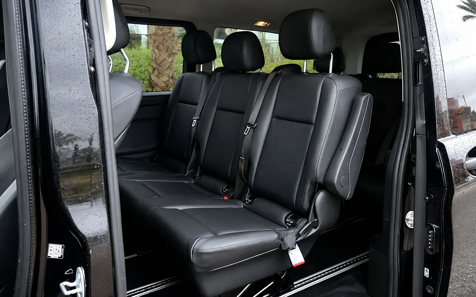 Interior of a private car in Tangier with black leather seats.